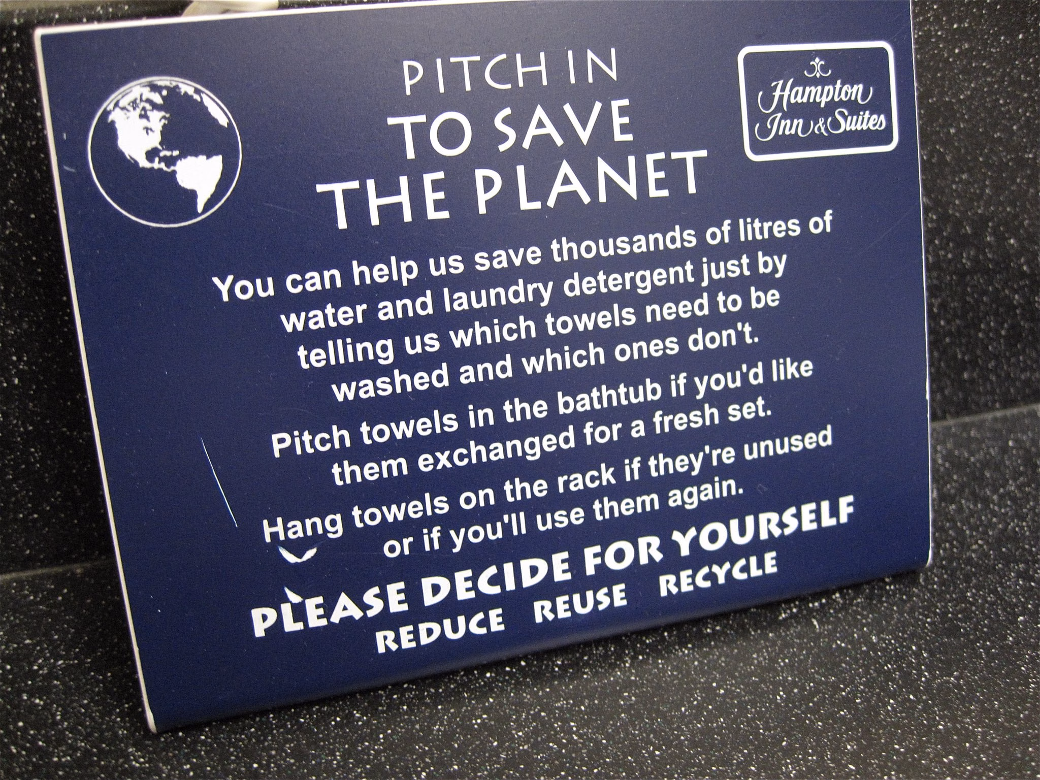 save the planet sign in a hotel
